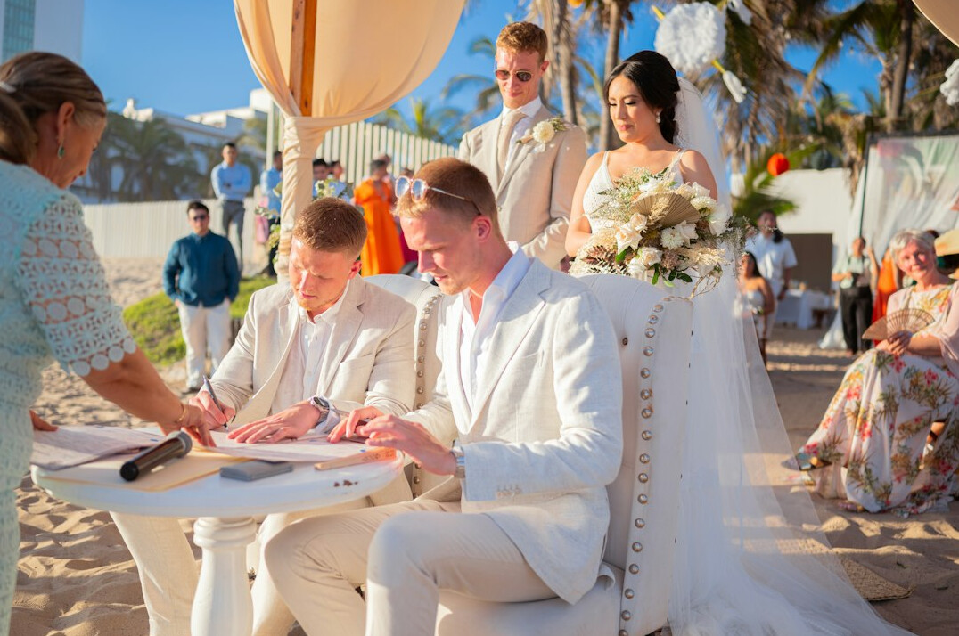 Hand signing business documents on a desk