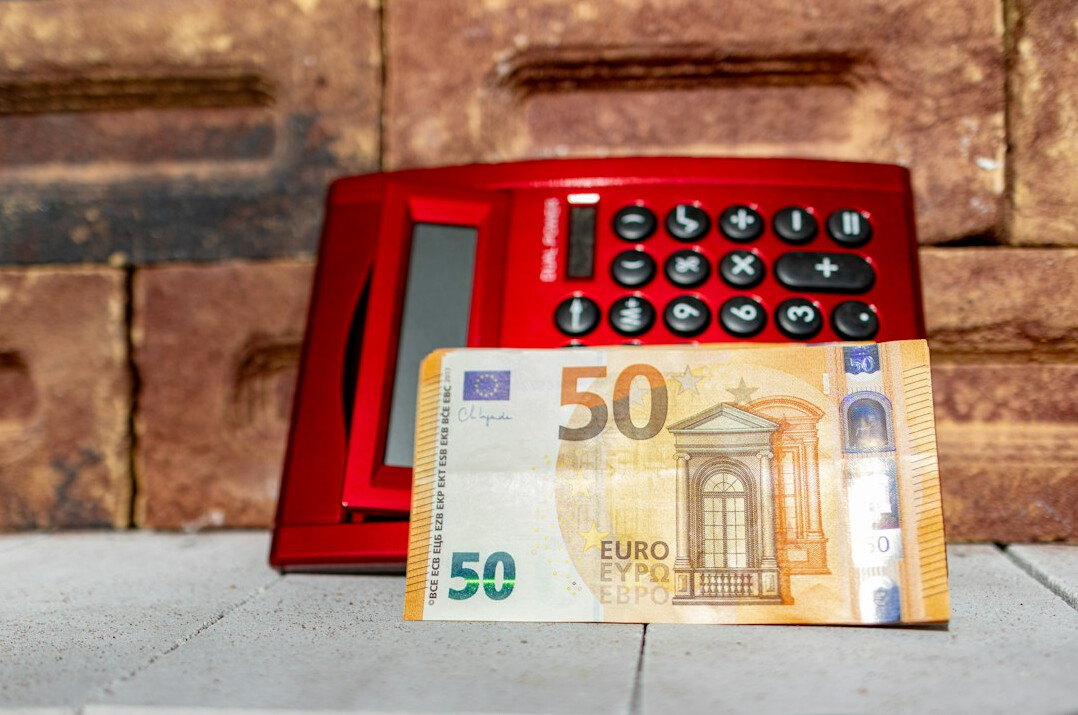Calculator and financial papers on a desk